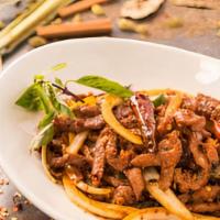 Basil Chili Lamb · Strips of lamb tossed with dried chili flakes, spices, jalapeños and onions; finished with b...