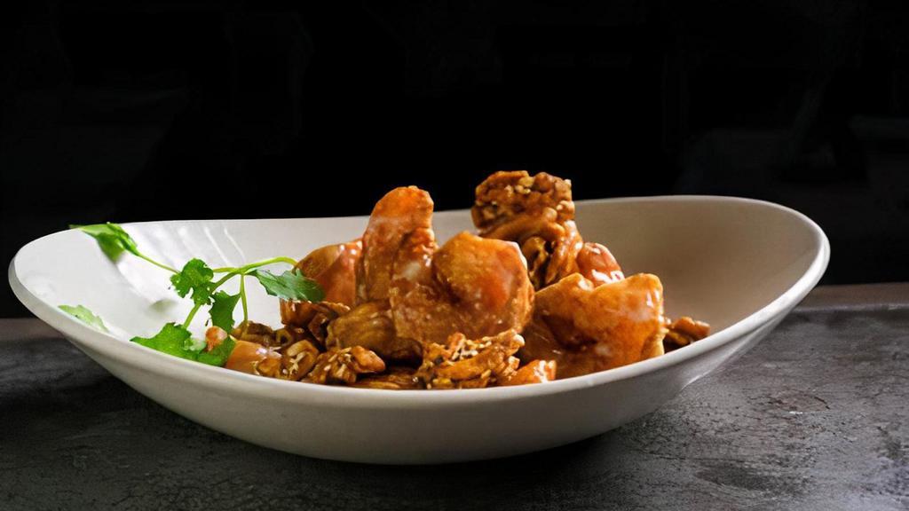 Walnut Shrimp · Lightly fried shrimp wok tossed with creamy sweet sauce, topped with toasted walnuts and sesame seeds.