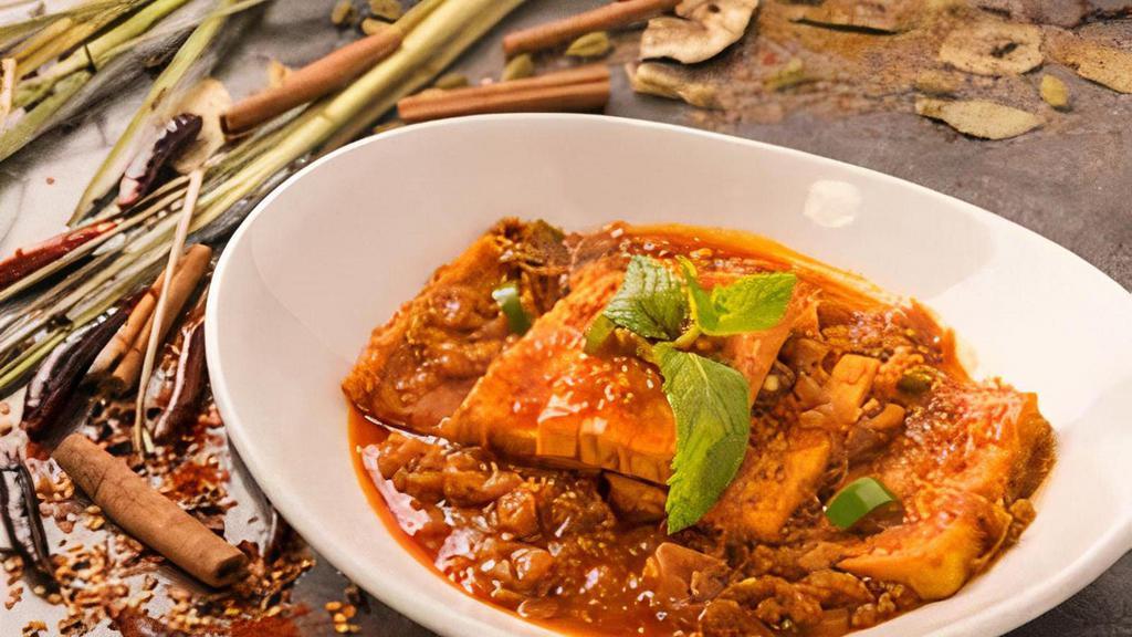 Yellow Tofu, Red Curry · Yellow bean tofu cooked in red Burmese-style curry.