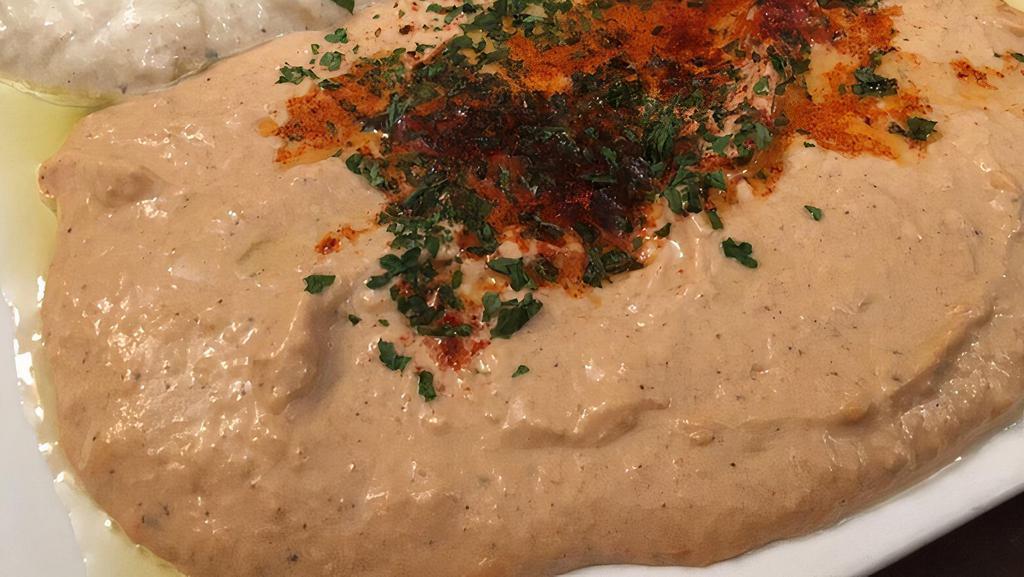 Baba Ghanoush · Smoke roasted eggplant blend with garlic, tahini, lemon, and touch of olive oil. Served with pita.