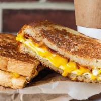 Breakfast Sandwich · 2 Scrambled egg on Buttermilk, Wheat, Sourdough. Choice of Bacon or Sausage. Cheese (America...