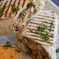 Chicken Kabob Sandwich · Marinated chicken breast grilled, hummus, lettuce, tahini sauce and salad.