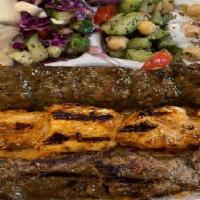 kabob trio plate · one chicken kabob, one lamb kabob, one kofta kabob over a bed of rice with a side of humus ,...