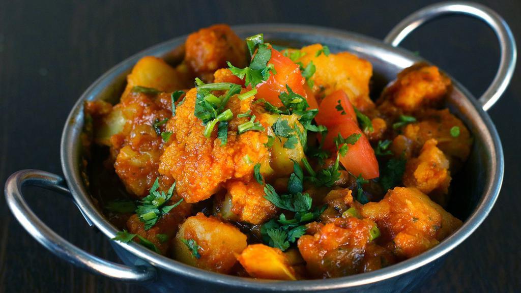 Aloo Gobi · Vegetarian. Fresh cauliflower and young potatoes cooked with onions, turmeric and fresh herbs.
