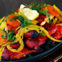 Tandoori Chicken · Char grilled chicken (on the bone) marinated in yogurt, ginger, garlic and spices.