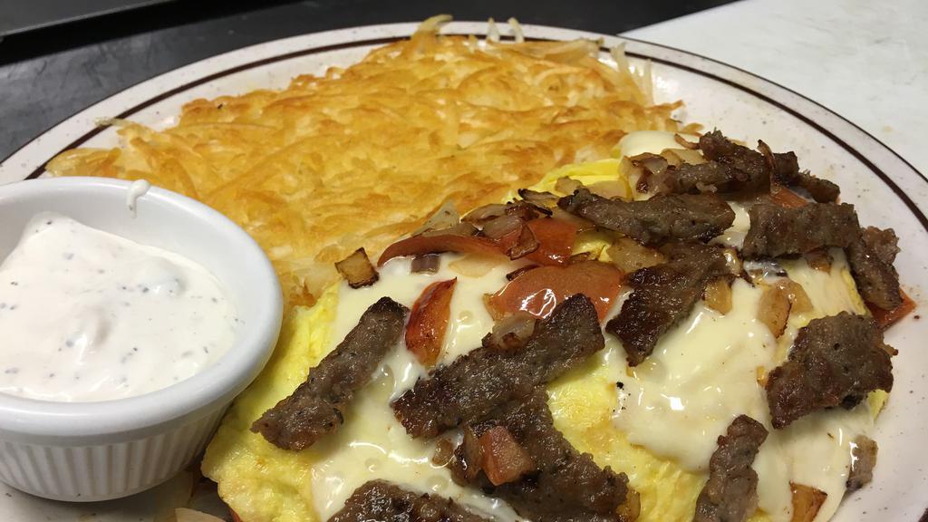 Greek Omelette · Filled with gyro, sautéed and tomatoes topped with feta cheese. Includes toast or pancake and hash brown or home fries.