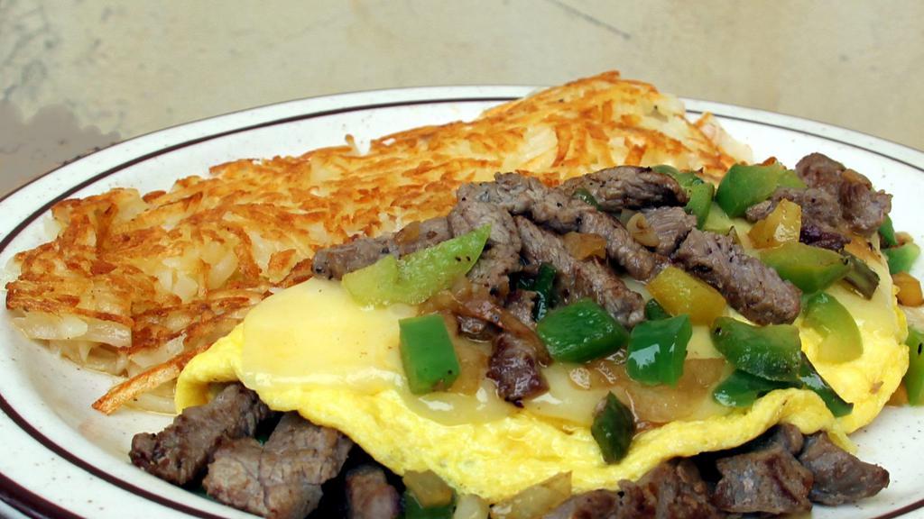 Steak Omelette · Marinated tri-tip, sautéed with onions and bell peppers, topped with your choice of cheese.