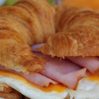 Breakfast Croissant · Grilled with ham or bacon, egg and American Cheese. Served with home fries or hash browns.