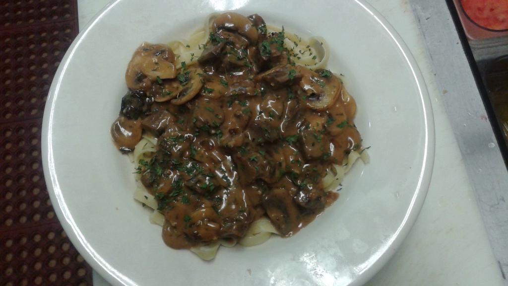 Beef Stroganoff · Sliced Beef sautéed with green onion, garlic, herbs & served with a creamy mushroom sauce over Fettuccini noodles.