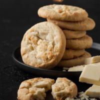 White Chocolate Macadamia · Fresh baked cookie dough loaded with white chocolate chips and buttery macadamia nuts.