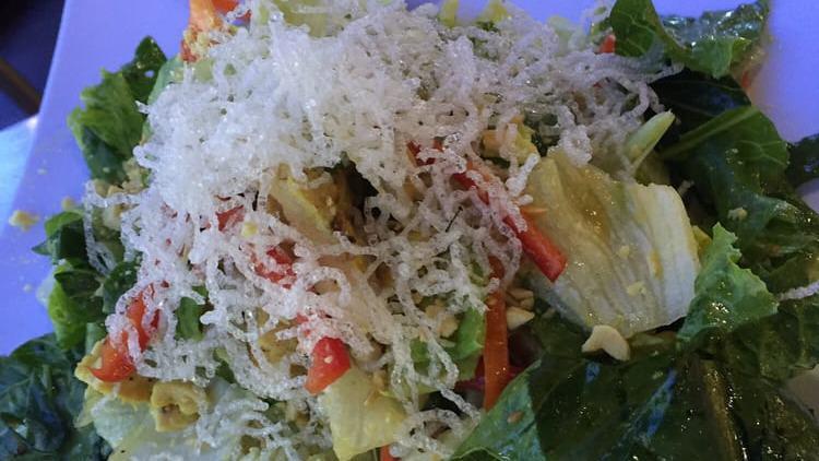 Traditional Caesar Salad · Romaine lettuce tossed in a creamy Caesar dressing, garlic croutons and shaved reggiano parmigiano.