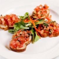 Bruschetta al Pomodoro · Toasted slices of bread topped with tomato cubes marinated with olive oil, garlic and basil.