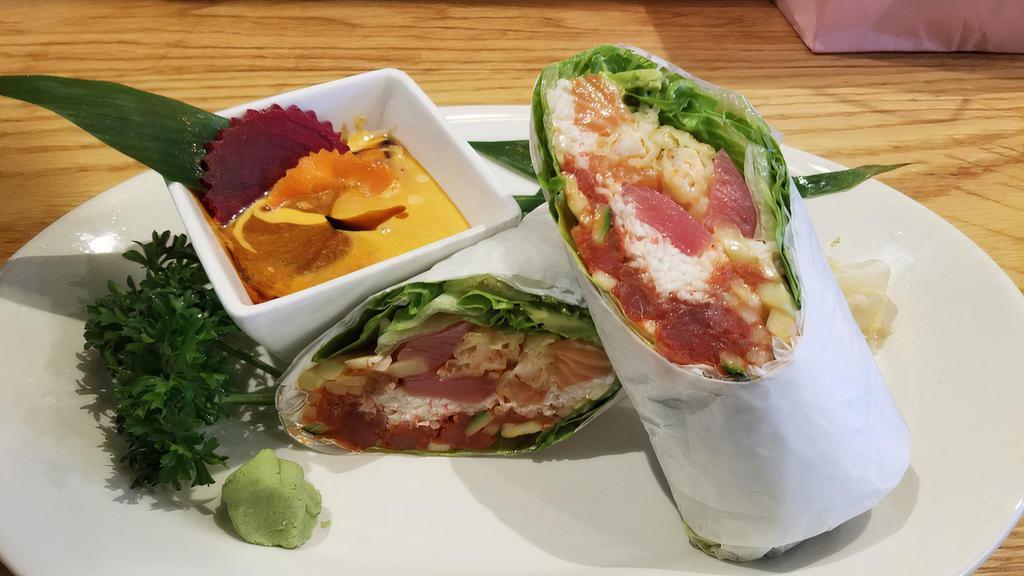Sushi Burrito · Raw.  shrimp tempura, crab, spicy tuna, seared tuna, salmon & avocado, wrapped in iceberg lettuce.
