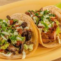 Classic Tacos (2) · Corn tortillas served with cabbage salad, your choice of protein, and smokey chile salsa. To...