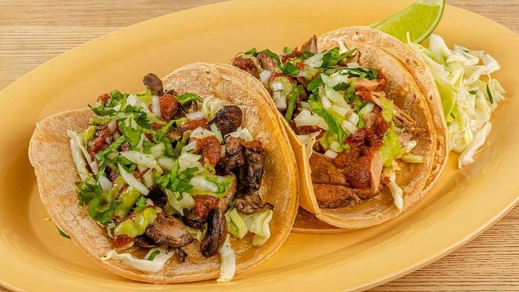 Classic Tacos (2) · Corn tortillas served with cabbage salad, your choice of protein, and smokey chile salsa. Topped with chopped cilantro & onions.