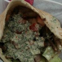 Chicken Shawarma Sandwich · Marinated chicken breast with lemon and garlic, hummus, lettuce, tomatoes, onion, and tahini...