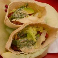 Avocado Falafel Sandwich (V) · Falafel with avocado, hummus, lettuce, tomatoes, and tahini sauce. Served in pita bread.
Vegan