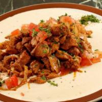 Shawarma Plate · Chicken or lamb and beef shawarma served with onions, tomatoes, tahini sauce, and hummus. Se...