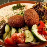 Vegetarian Combo (V) · Tabouli, baba ghanouj, hummus, rice and lentils, tomato and cucumber salad, falafel, and dol...