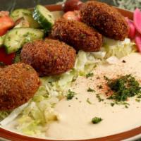 Falafel Plate (V) · Four pieces of falafel served on a bed of tomatoes and lettuce. Served with a side of hummus...