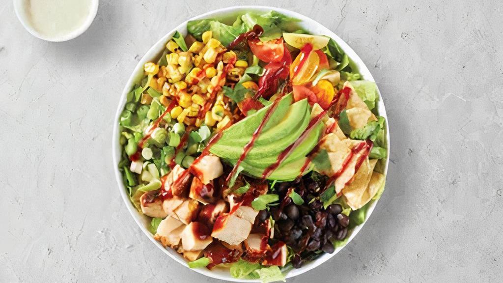 Southwest Chicken · Fresh grilled barbeque chicken, chopped hearts of Romaine, avocado, black beans, cherry tomatoes, roasted corn, cilantro, green onions and corn chips with avocado-ranch dressing on the side.