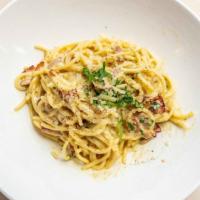 Spaghetti Carbonara · Sauteed pancetta, egg yolks, Parmesan cheese, black pepper.