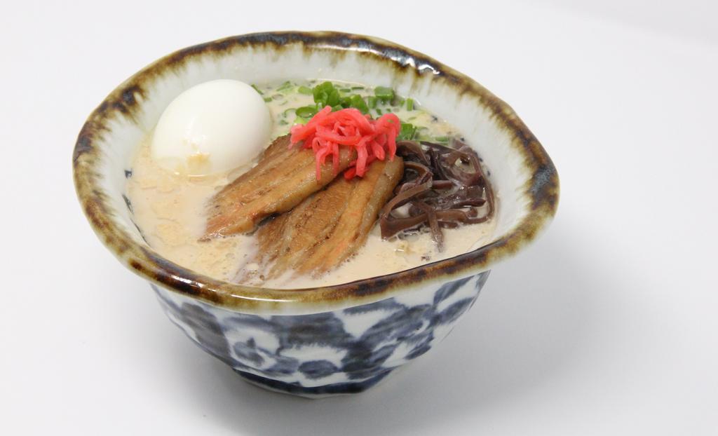 Hakata Tonkotsu · Hakata style ramen with rich pork broth. Chashu pork (simmered pork belly), seasoned soft boiled egg, green onions, kikurage mushrooms, and bean sprouts. Top with Sesame Seeds