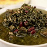 Ghormeh Sabzi Stew · Hot, inviting stew of sautéed vegetables, dried limes, beef, and kidney beans. Served with b...