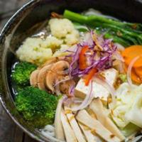 N6. Vegetable Noodle · Pho Noodle in Vegetable Soup with Seasonal Vegetables & Soft Tofu, Topped with Fresh Ginger.