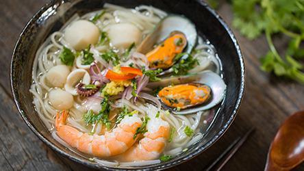 N5. Seafood Noodle · Pho Noodle in Chicken Soup with Shrimp, Calamari, Scallop, Fish Ball & Mussels, Topped with Fresh Ginger.
