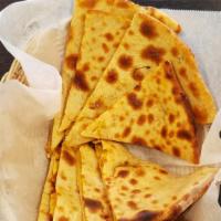 Aloo Paratha · Whole wheat bread stuffed with potatoes & spices and served wtih yogurt