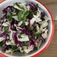 Mixed Cabbage Slaw (v) · Red and green cabbages with jalapeño, parsley, and lime dressing. Vegan.