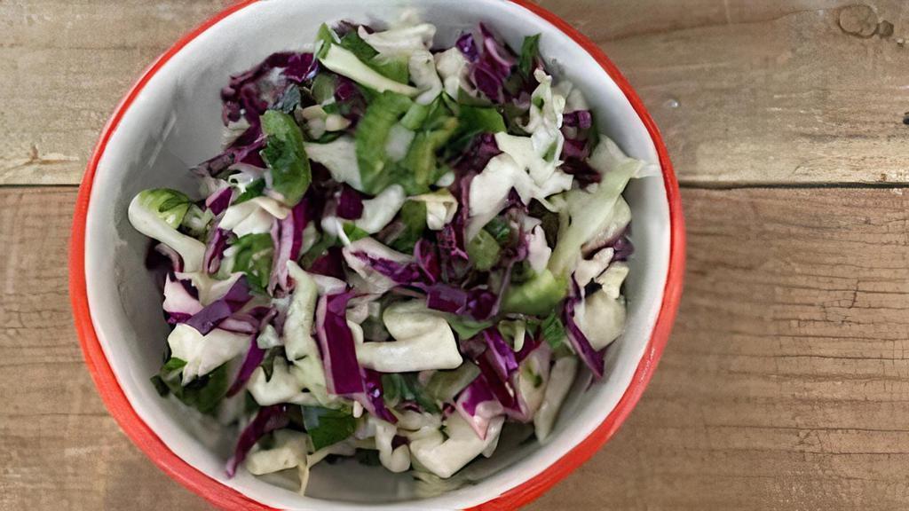 Mixed Cabbage Slaw (v) · Red and green cabbages with jalapeño, parsley, and lime dressing. Vegan.