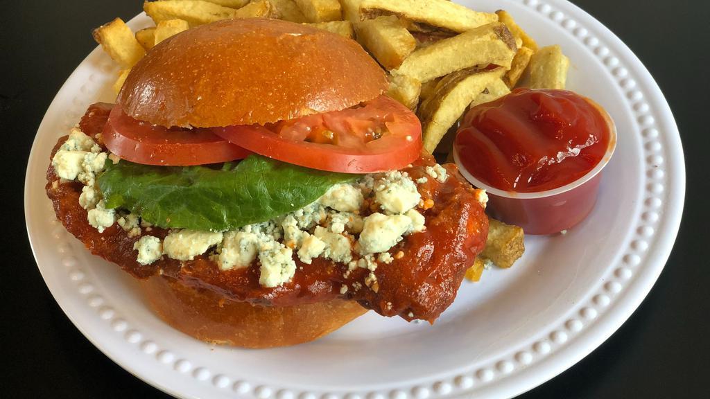 Buffalo Hot Fried Chicken Sandwich · Buttermilk fried chicken, tossed in a sriracha hot sauce with blue cheese, lettuce, tomato, and served on a toasted bun.