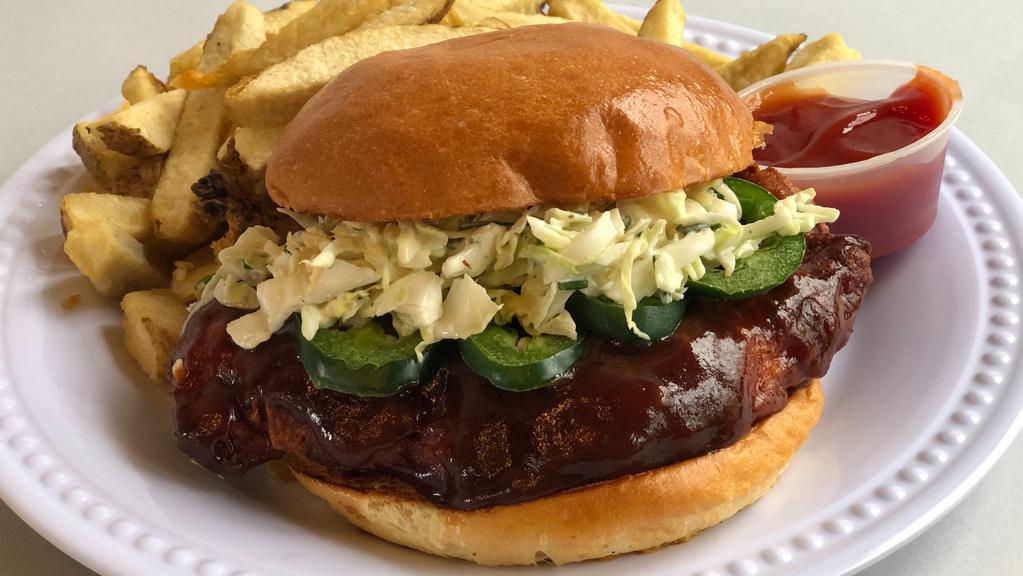 BBQ Fried Chicken Sandwich · Buttermilk fried chicken, BBQ sauce, jalapeños, cabbage slaw, and served on a toasted bun.