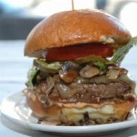 The Venice Burger · Mushrooms and Swiss cheese served on a perfect brioche bun with caramelized onions, chipotle...