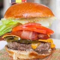 The Berlin Burger · Bacon, Cheddar, jalapeños, caramelized onions black pepper mayo on a brioche bun. Served wit...
