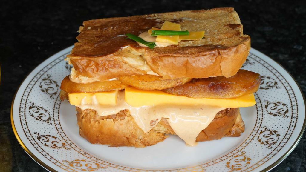 Caramelized Pear, Chipotle & Cheddar French Toast Sandwich · The sweetness of the pear and the sharpness of the Cheddar. You can eat it anytime. Served with butter and syrup.