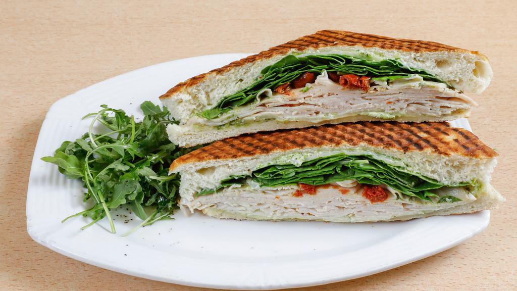 Turkey Panini · Oven-roasted turkey, basil pesto, provolone cheese, tomatoes topped with fresh spinach on focaccia.