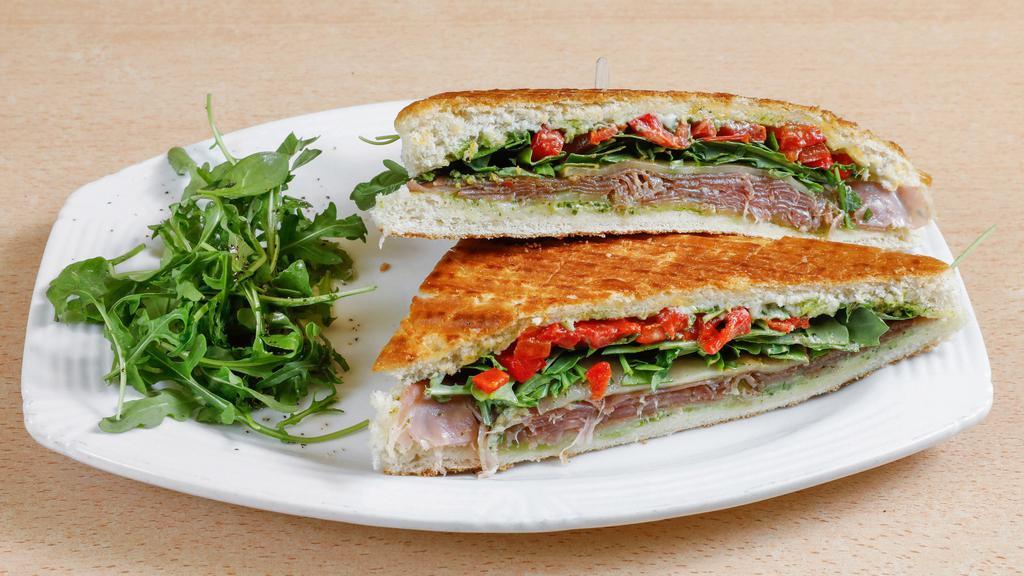 Prosciutto Panini · Aged prosciutto, basil pesto, provolone cheese, roasted bell peppers with fresh greens on focaccia.