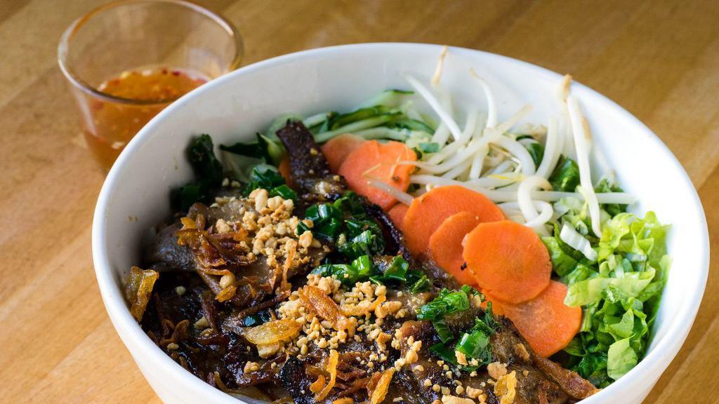 Bun Thit Nuong · Grilled lemongrass pork shoulder. Served with cucumber, lettuce, bean sprouts, pickled daikon and carrots, and peanuts.