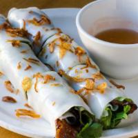 Hue Rolls · Grilled lemongrass pork, shiso, mint, cilantro, fried shallots, and steamed rice paper.