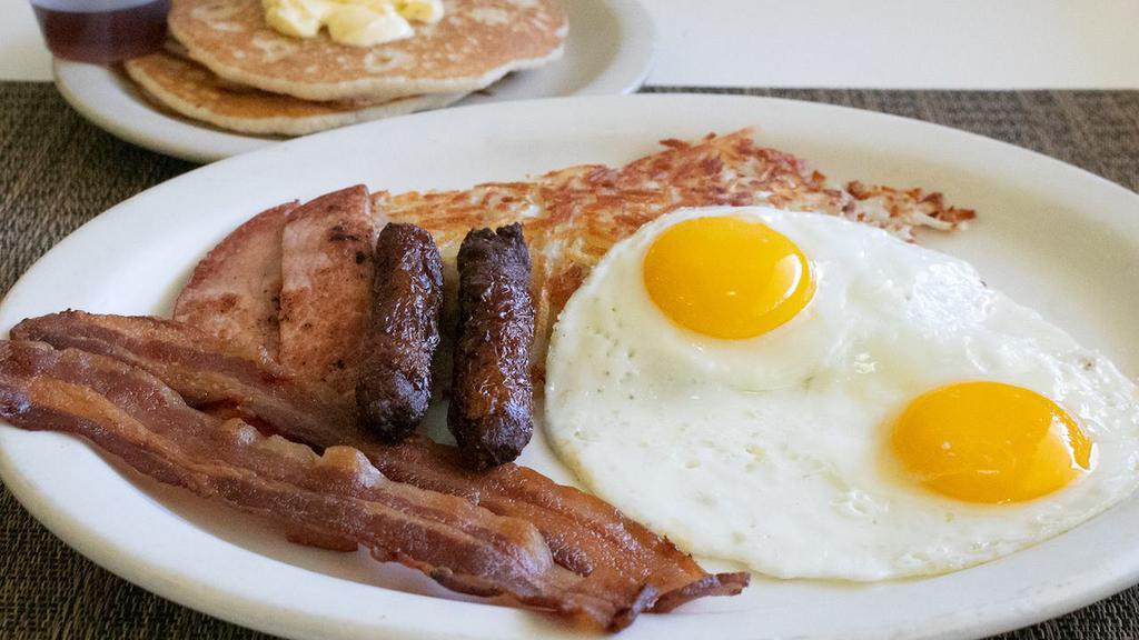 Big Breakfast · Two eggs, two bacon strips, two ink sausages. two ham strips, hash browns & two pancakes.