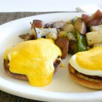Eggs Benedict · Two poached eggs, four slices of Canadian bacon & English muffin topped hollandaise sauce. C...