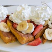 Fruit French Toast (3 Slices) · Served with strawberries bananas and whipped cream.