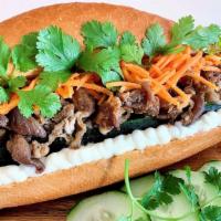 Grilled Pork Banh Mi · Grilled, house-marinated pork with pickled carrots, fresh cucumber, cilantro, and jalapeños ...
