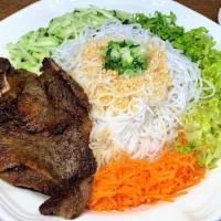 Grilled Pork Chop Vermicelli · Grilled, house-marinated pork chop on a bed of vermicelli noodles and sliced vegetables. Ser...