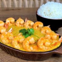 Curry Shrimp and Rice · White shrimp with our housemade curry cooked from a chicken broth base. Served on a bed of j...
