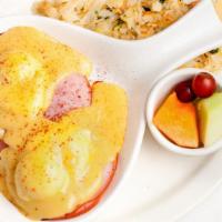 Eggs Benedict · Poached eggs, smoked ham and hollandaise sauce on an English muffin. Served with hash browns...