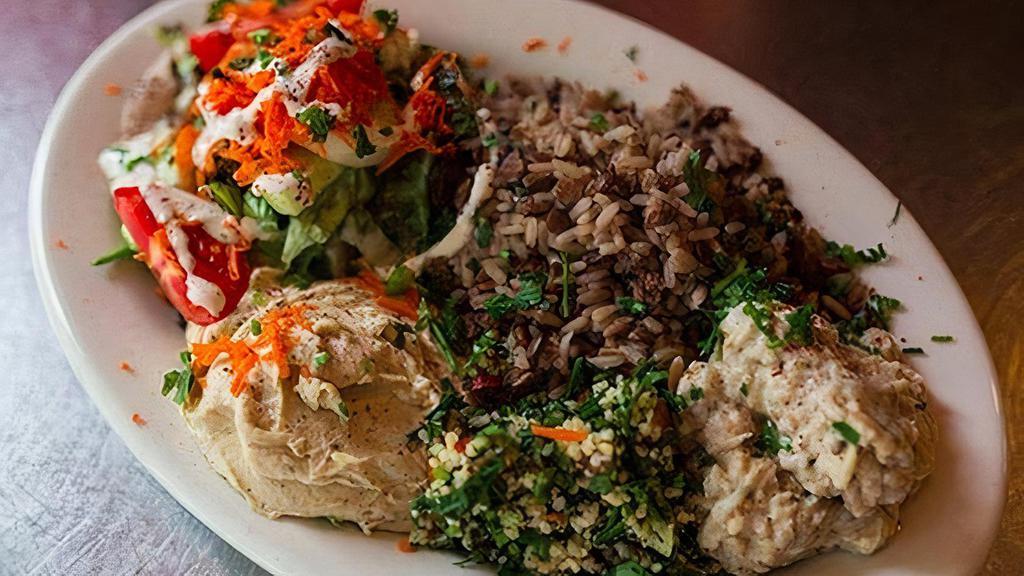 Mediterranean Plate · Lentil rice. Served with hummus, falafel, tabbouleh, pita bread, and green salad topped with tahini.